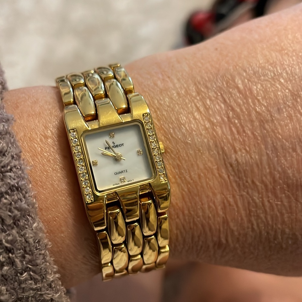 Peugeot goldtone watch for 7 inch wrist or smaller. “Marble” look in the back.